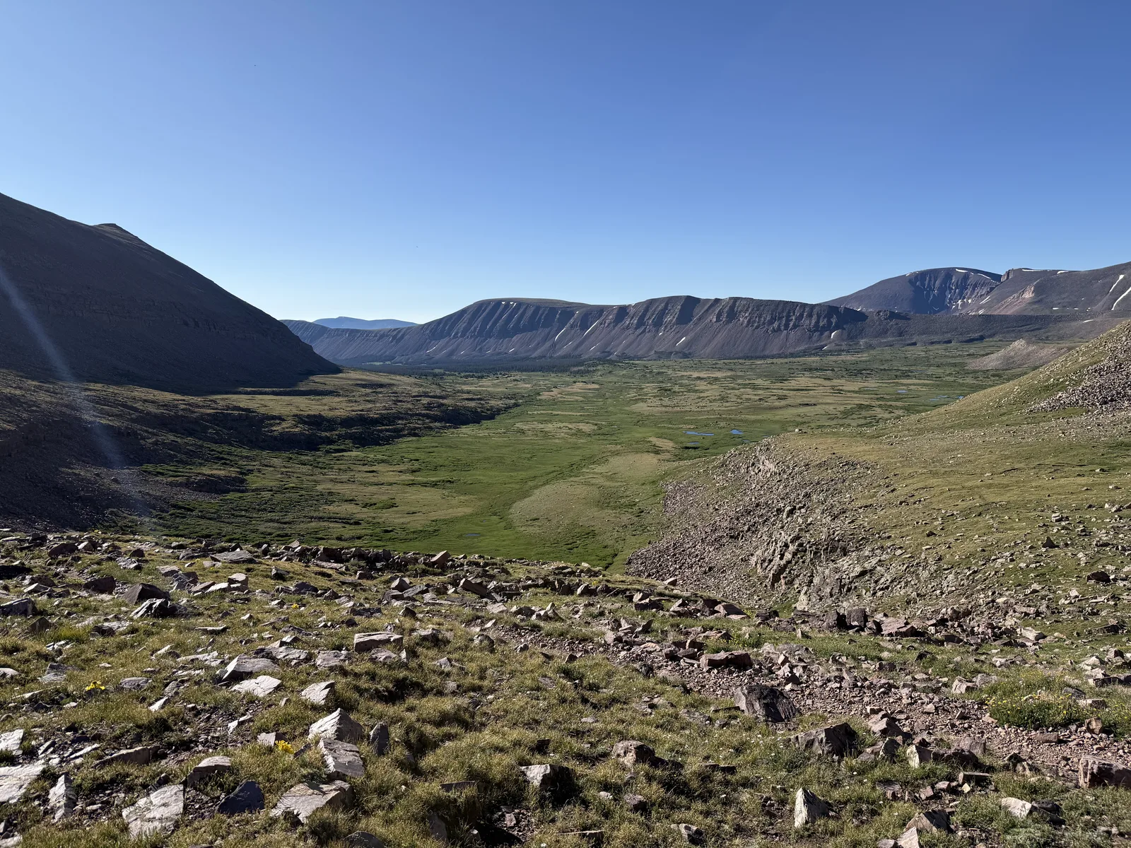 Gunsight Pass cairn with surrounding peaks